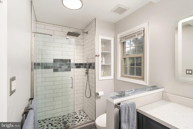 full bathroom with a shower stall, toilet, and vanity