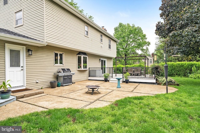 view of patio with a gazebo, a deck, grilling area, and a fire pit