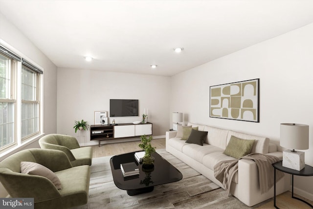 living area with wood finished floors and baseboards