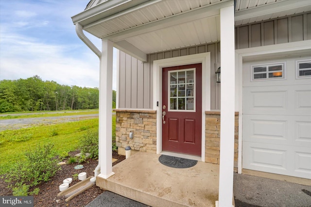 112 Veery Way, Port Matilda, PA 16870 - doorway to property featuring board and batten siding and a garage