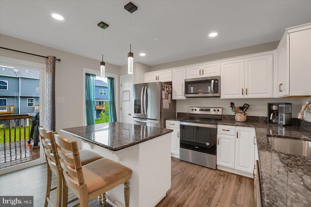 112 Veery Way, Port Matilda, PA 16870 - kitchen with appliances with stainless steel finishes, a sink, light wood-style flooring, white cabinetry, and recessed lighting