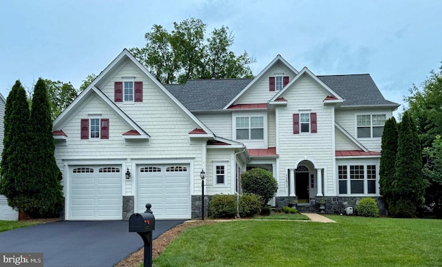 15673 Altomare Trace Way, Woodbridge, VA 22193 - craftsman house featuring asphalt driveway, a standing seam roof, stone siding, a front lawn, and a garage