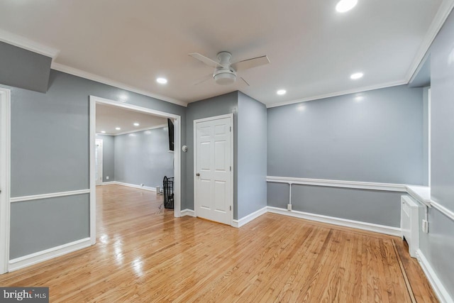 spare room with ceiling fan, light wood-type flooring, crown molding, recessed lighting, and baseboards