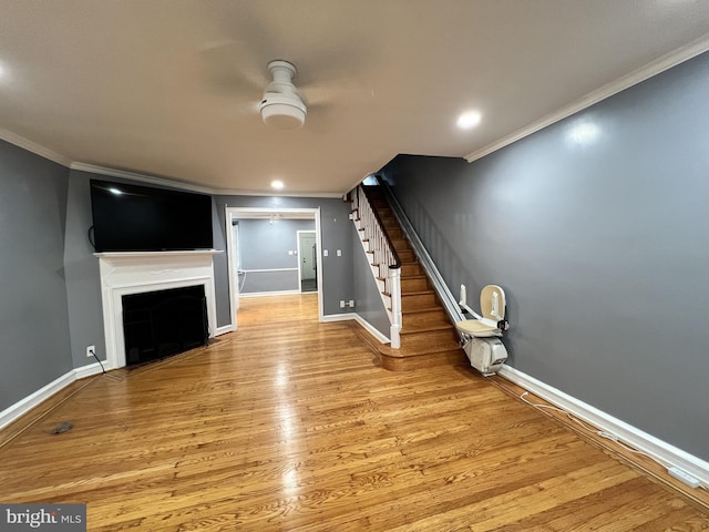 2322 79th Ave, Philadelphia, PA 19150 - unfurnished living room with crown molding, stairs, light wood-type flooring, a fireplace with flush hearth, and recessed lighting
