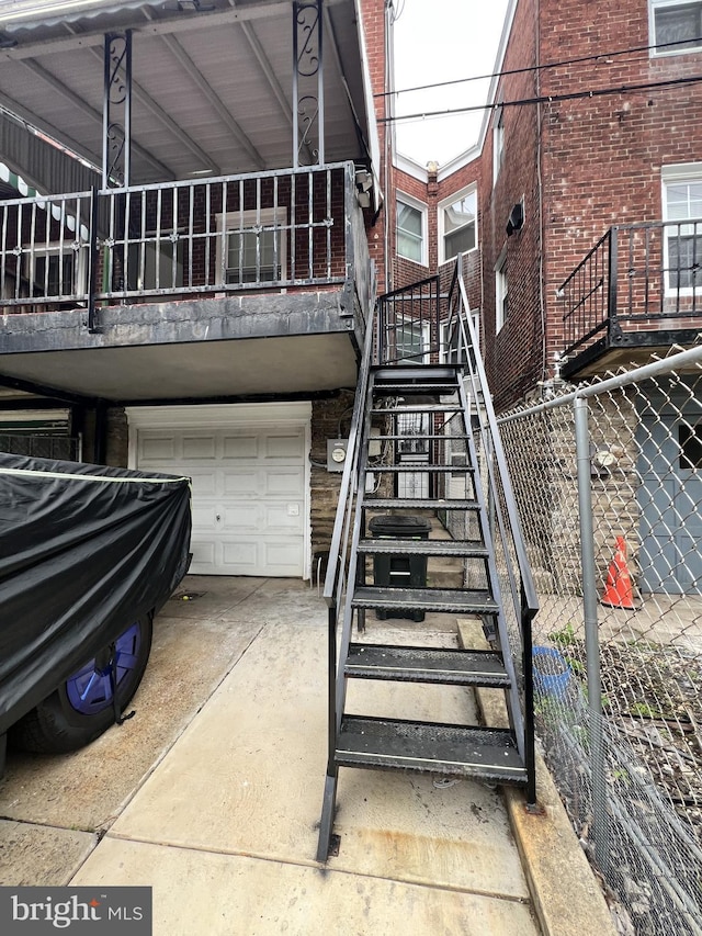 2322 79th Ave, Philadelphia, PA 19150 - rear view of house with stairs, a garage, and brick siding