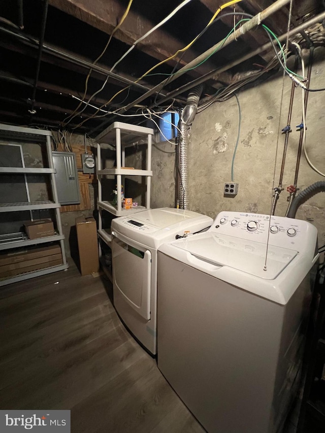 clothes washing area with washing machine and clothes dryer and electric panel