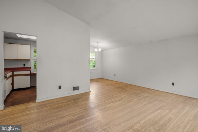 13111 Valleywood Dr, Silver Spring, MD 20906 - unfurnished room with light wood-style floors, a chandelier, lofted ceiling, and baseboards