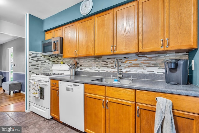 16 Bayberry Dr, Lanoka Harbor, NJ 08734 - kitchen featuring white appliances, a sink, decorative backsplash, dark countertops, and brown cabinetry
