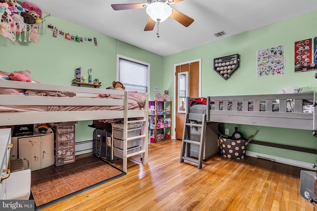 16 Bayberry Dr, Lanoka Harbor, NJ 08734 - bedroom with wood finished floors, a baseboard heating unit, and a ceiling fan