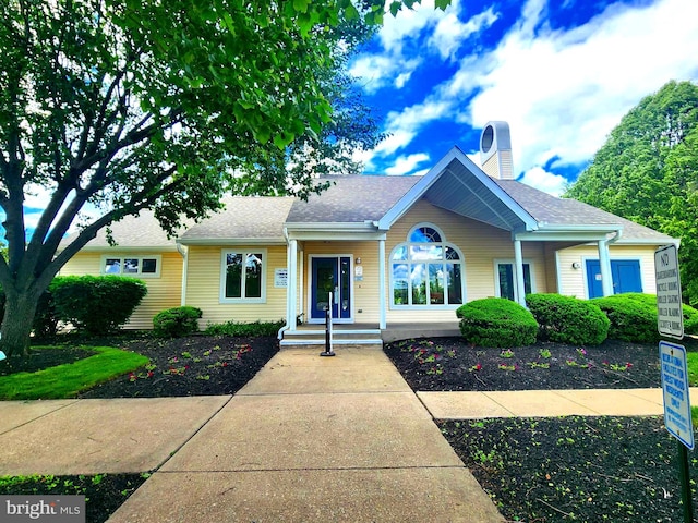36 Lauren Ct, Levittown, PA 19057 - view of front facade with a chimney and a shingled roof