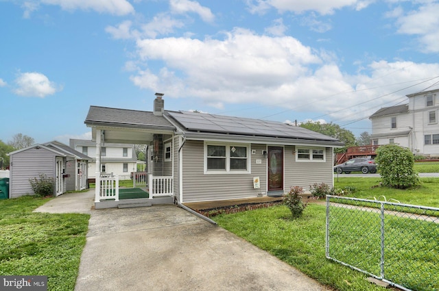 337 W Perry St, Enola, PA 17025 - view of front of house featuring solar panels, covered porch, a chimney, and an outdoor structure