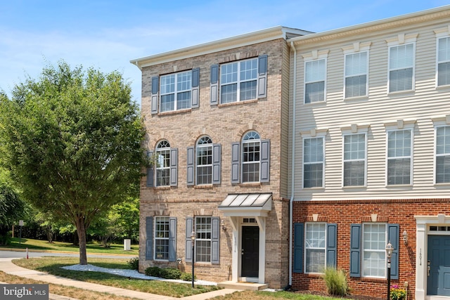 view of front of house featuring brick siding