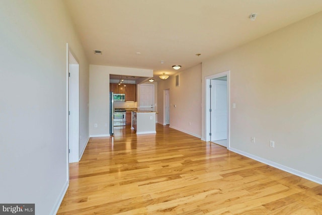 2200 N Westmoreland St Unit 325, Arlington, VA 22213 - unfurnished living room featuring light wood-style flooring and baseboards