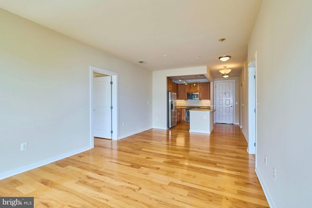 2200 N Westmoreland St Unit 325, Arlington, VA 22213 - unfurnished living room featuring light wood-style flooring and baseboards