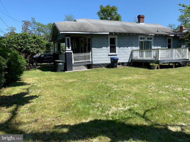 4333 Hayes St NE, Washington, DC 20019 - back of property with a chimney, a lawn, a wooden deck, and roof with shingles