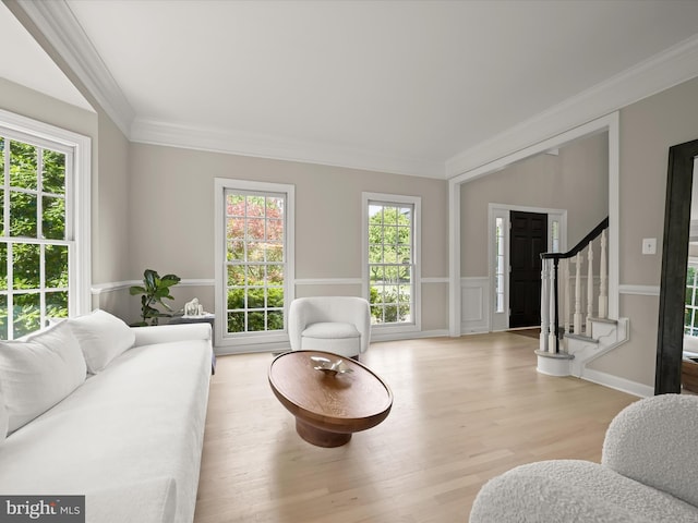 720 Cyprian Ct, Gambrills, MD 21054 - living area with wood finished floors, ornamental molding, stairs, healthy amount of natural light, and wainscoting