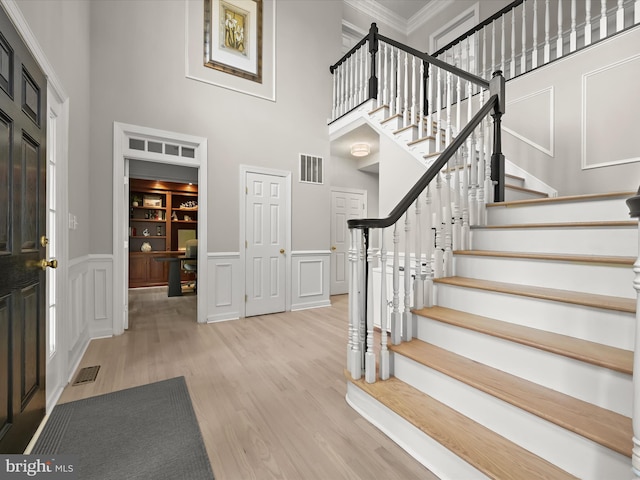 720 Cyprian Ct, Gambrills, MD 21054 - foyer entrance featuring a decorative wall, a high ceiling, wood finished floors, ornamental molding, and stairway