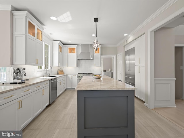 720 Cyprian Ct, Gambrills, MD 21054 - kitchen with wall chimney exhaust hood, premium appliances, a sink, a kitchen island, and white cabinets