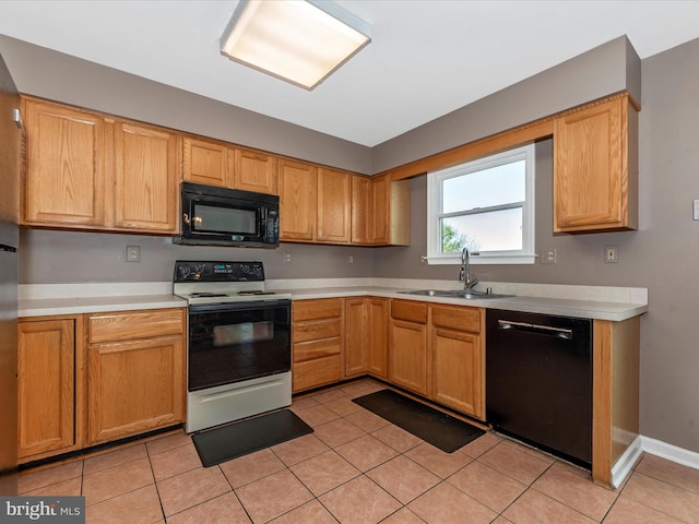 kitchen featuring black appliances, a sink, light countertops, and light tile patterned floors
