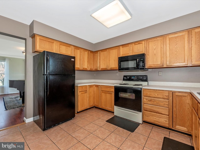 kitchen featuring black appliances, light countertops, and light tile patterned floors