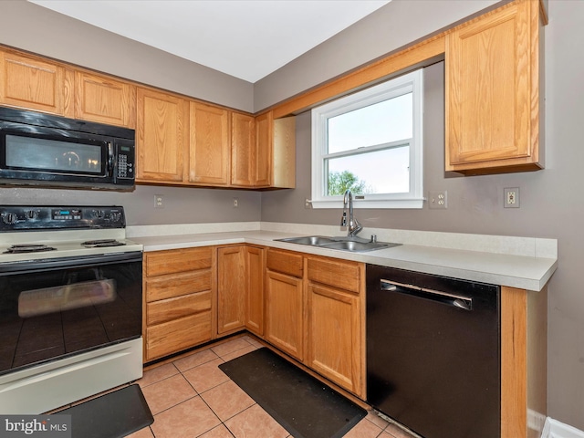 kitchen with black appliances, a sink, light countertops, and light tile patterned flooring