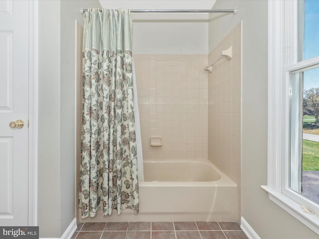 bathroom with baseboards, shower / bath combination with curtain, and tile patterned floors