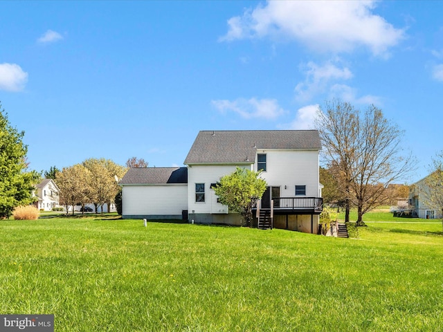 rear view of property featuring a deck, a yard, and stairway