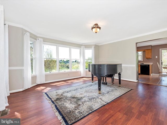 sitting room with dark wood finished floors, baseboards, and ornamental molding