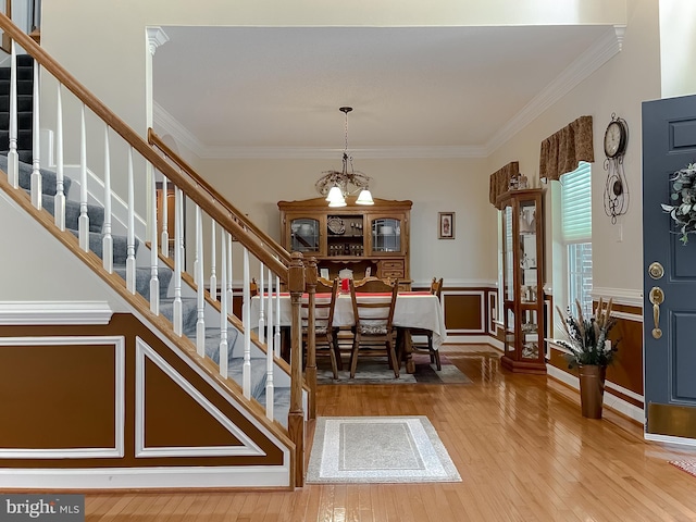 9150 Sparkling Pl, Charlotte Hall, MD 20622 - entryway featuring stairs, hardwood / wood-style flooring, ornamental molding, a chandelier, and wainscoting