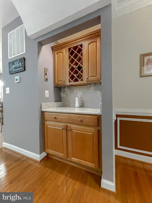 9150 Sparkling Pl, Charlotte Hall, MD 20622 - indoor dry bar with light wood-type flooring, backsplash, and baseboards