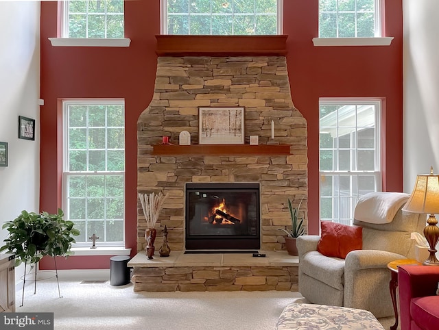 9150 Sparkling Pl, Charlotte Hall, MD 20622 - living room with carpet, a towering ceiling, a stone fireplace, and plenty of natural light
