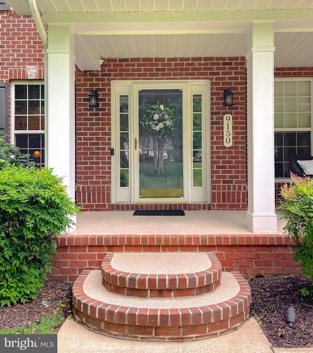 9150 Sparkling Pl, Charlotte Hall, MD 20622 - view of exterior entry featuring covered porch and brick siding
