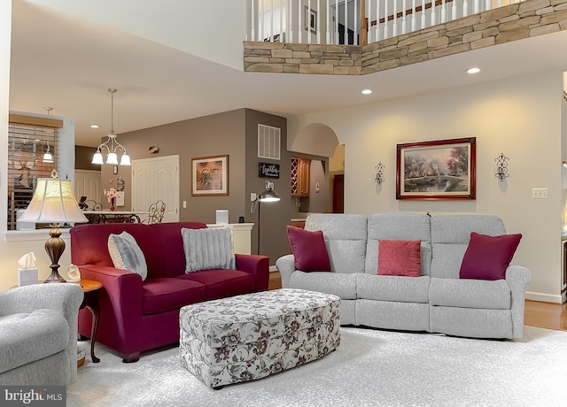 9150 Sparkling Pl, Charlotte Hall, MD 20622 - living room with arched walkways, recessed lighting, a high ceiling, and a chandelier