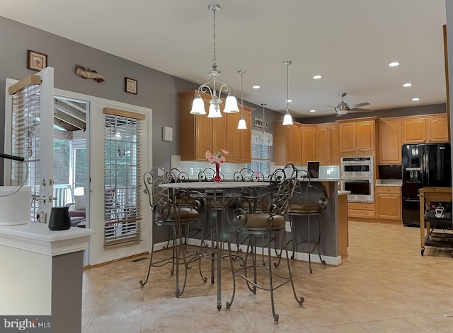 9150 Sparkling Pl, Charlotte Hall, MD 20622 - kitchen with black refrigerator with ice dispenser, backsplash, a ceiling fan, a breakfast bar area, and recessed lighting
