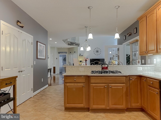 9150 Sparkling Pl, Charlotte Hall, MD 20622 - kitchen featuring stainless steel gas stovetop, decorative backsplash, hanging light fixtures, a peninsula, and light tile patterned floors