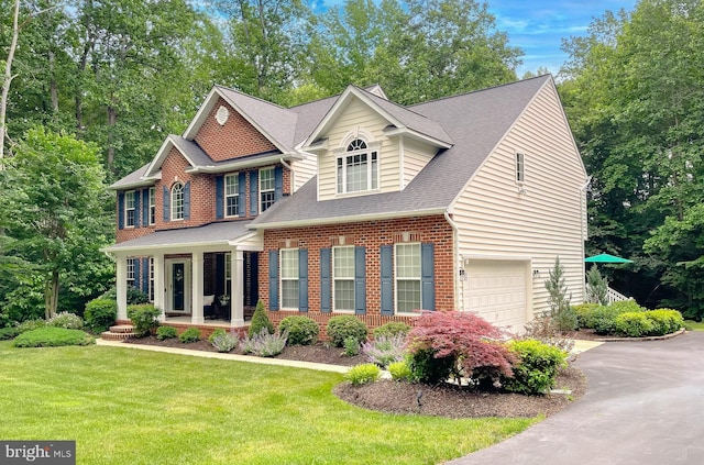 9150 Sparkling Pl, Charlotte Hall, MD 20622 - view of front of property featuring driveway, an attached garage, a front yard, brick siding, and a shingled roof