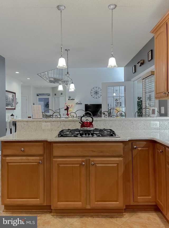 9150 Sparkling Pl, Charlotte Hall, MD 20622 - kitchen featuring light stone countertops, hanging light fixtures, open floor plan, and gas cooktop