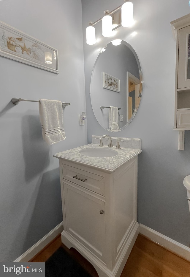 9150 Sparkling Pl, Charlotte Hall, MD 20622 - bathroom featuring vanity, baseboards, and wood finished floors