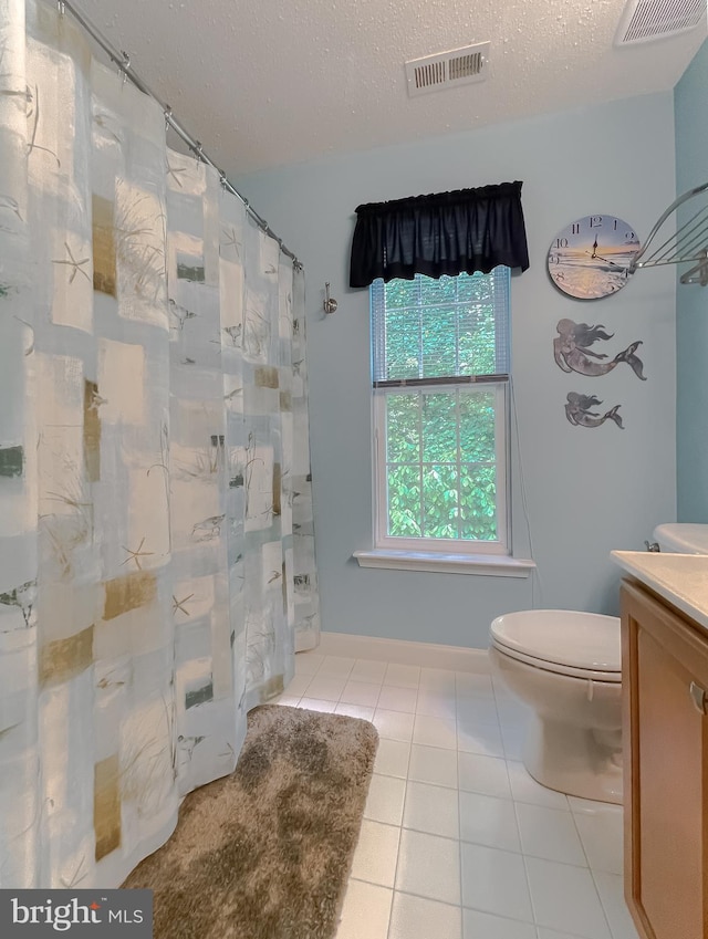 9150 Sparkling Pl, Charlotte Hall, MD 20622 - bathroom featuring vanity, toilet, tile patterned flooring, a textured ceiling, and a shower with curtain