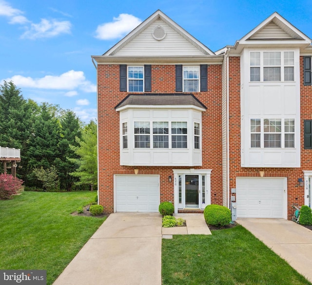 view of front of property featuring concrete driveway, a front lawn, brick siding, and an attached garage