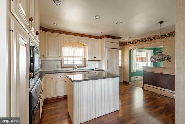 904 W Main St, New Holland, PA 17557 - kitchen featuring a baseboard heating unit, a sink, dark countertops, a center island, and dark wood-style floors