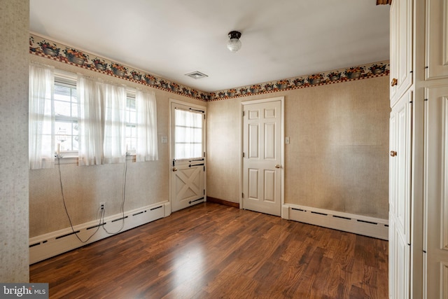 904 W Main St, New Holland, PA 17557 - empty room featuring a baseboard heating unit, wood finished floors, and healthy amount of natural light