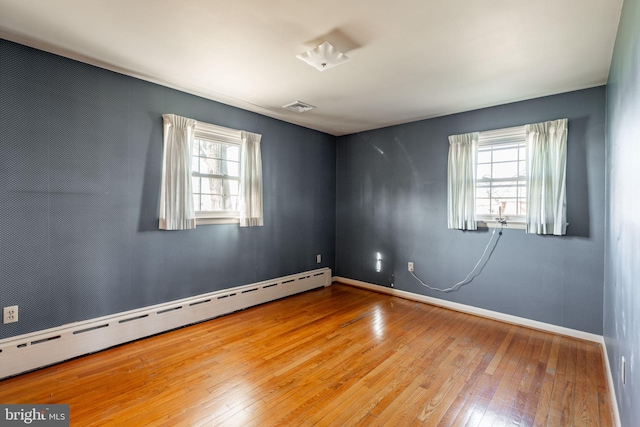 904 W Main St, New Holland, PA 17557 - spare room with a baseboard radiator, healthy amount of natural light, wood-type flooring, and baseboards