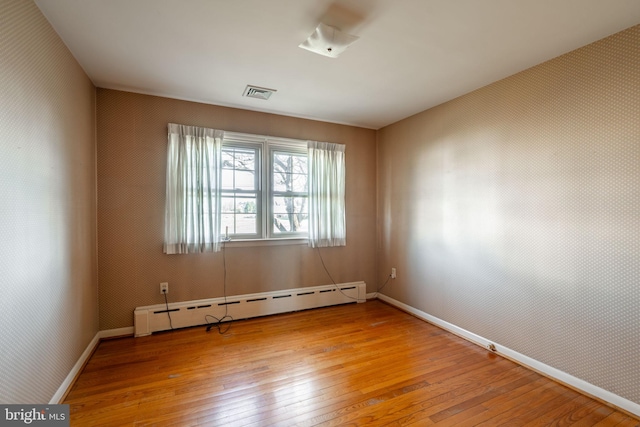 904 W Main St, New Holland, PA 17557 - spare room featuring a baseboard radiator, light wood-style flooring, and baseboards