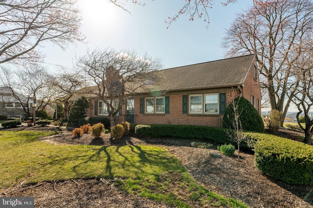 904 W Main St, New Holland, PA 17557 - view of front of home with brick siding, a front lawn, and a shingled roof