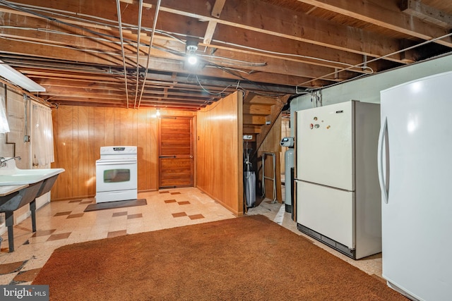 904 W Main St, New Holland, PA 17557 - unfinished basement featuring freestanding refrigerator, light floors, a sink, and wooden walls