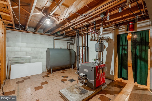 904 W Main St, New Holland, PA 17557 - unfinished basement with oil tank, tile patterned floors, a heating unit, and water heater