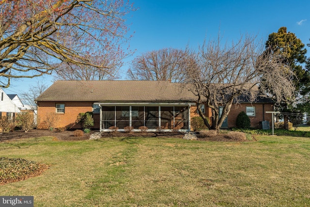 904 W Main St, New Holland, PA 17557 - back of property featuring a sunroom, brick siding, a yard, and roof with shingles