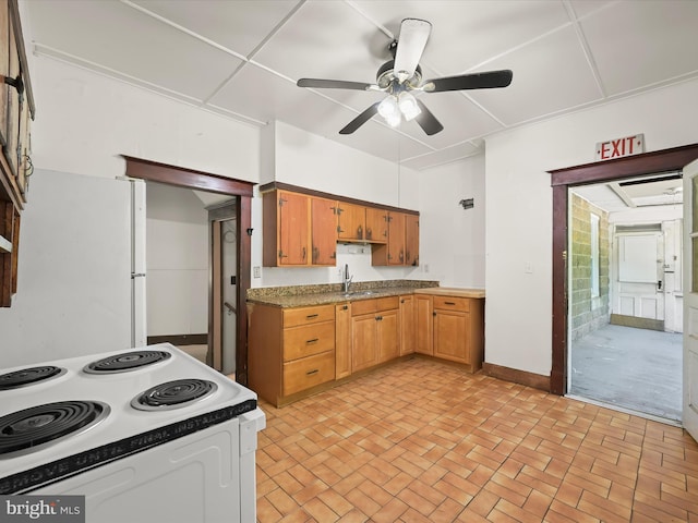 1812 64th Ave, Landover, MD 20785 - kitchen featuring white electric range, a sink, ceiling fan, brick patterned floors, and baseboards
