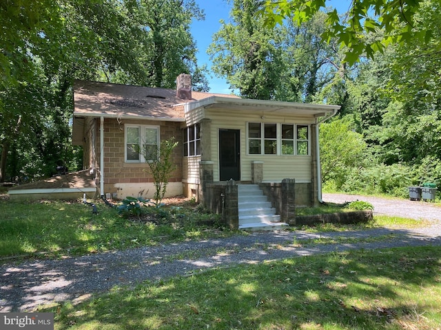 1812 64th Ave, Landover, MD 20785 - view of front facade featuring a chimney and a front lawn
